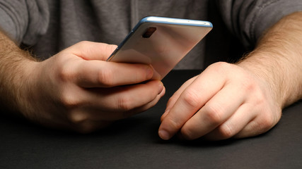 Close up of a man using mobile smart phone. Smartphone in male hands