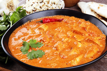 Chicken tikka masala spicy curry meat food in pot with rice and naan bread. indian food