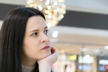 Pensive beautiful brunette girl posing leaning her chin on her hand