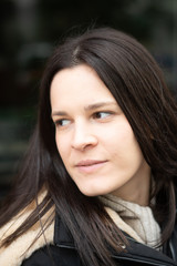 Close-up portrait of an attractive young brunette woman looking away