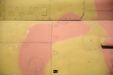 Dirty detailed texture of old fighter aircraft body painted in camouflage with many rivets