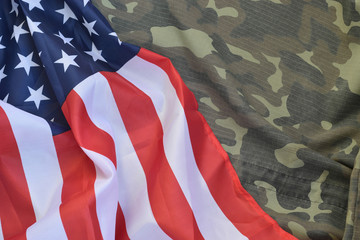 United States of America flag and folded military uniform jacket. Military symbols conceptual...