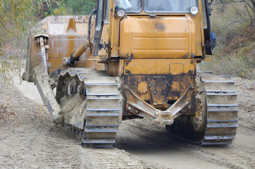 Quarry aggregate with heavy duty machinery. Caterpillar loader Excavator with backhoe driving to...