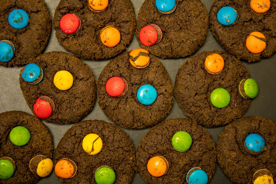Chocolate Cookies with colorful chocolate candy on Black background