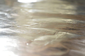 Gloss of aluminum foil in a roll and in sheets.