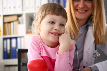 Cute little girl visiting family doctor office portrait