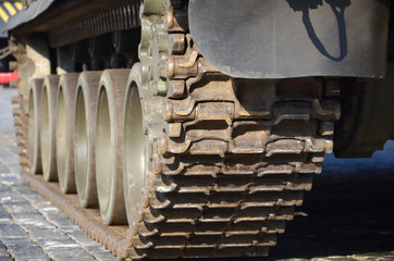 Close up of green armoured caterpillar transport. Modern military transportation vehicle...