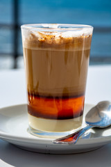 Special coffee of Canary islands, sweet barraquito coffee with layers and alcohol served in glass