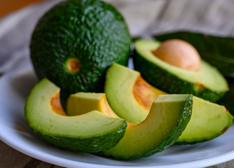 Fresh ripe green avocados with seeds ready to eat