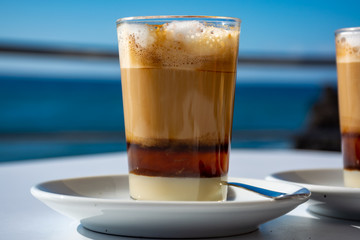 Special coffee of Canary islands, sweet barraquito coffee with layers and alcohol served in glass