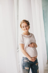 Young beautiful pregnant woman in vintage interior
