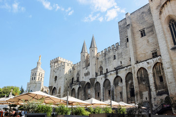 exterior facade of Palais des papes with blue sky in Avignon