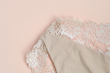 Beige women underwear with lace on paper background with copy space. Beauty fashion blogger...