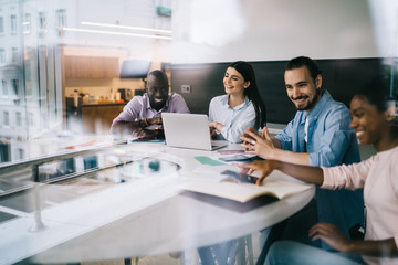 Happy young group of people working in office