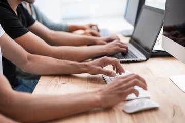 close up. a group of employees work on their computers