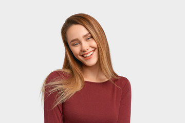 Beautiful euphoric teenage girl enjoying weekend at home, looking and smiling at camera. Beautiful...