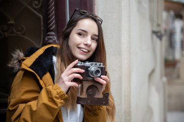 Photo of young tourist girl exploring streets of Baku. Moody photos of teenager girl visiting old city and taking photos of the city