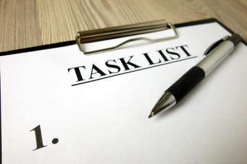 Clipboard with task list and pen on desk