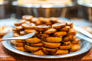 Plain Kahk traditional Arabian cookies with shallow depth of field. Eastern cookies beautifully served on metal plate. Traditional desert in Egypt.