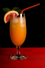 Grapefruit juice with ice in a steamed glass. A steamed glass of ice. Juice with ice. Slice of grapefruit in a glass of juice.