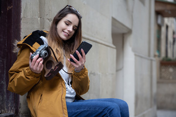 Photo of young tourist girl exploring streets of Baku. Moody photos of teenager girl visiting old city and taking photos of the city