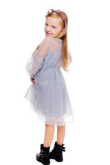 Little fashionable red-haired girl in a gray dress, with a wreath on his head and black boots on a white background