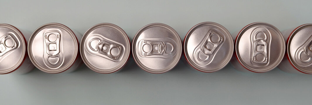 Many New Aluminium Cans Of Soda Soft Drink Or Energy Drink Containers. Drinks Manufacturing Concept And Mass Production