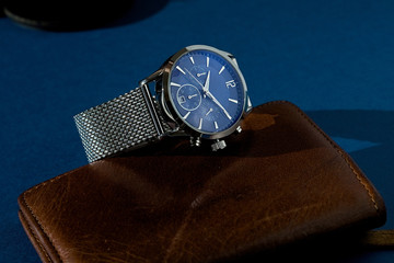 luxury fashion watch with blue dial and metal bracelet