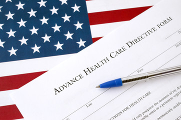 Advance health care directive blank form and blue pen on United States flag