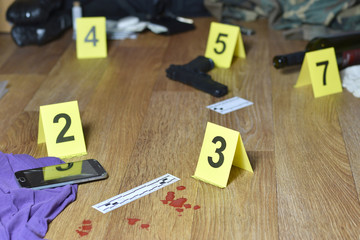 Id tents at crime scene after gunfight indoors. Blood and gun cartridges as evidence on crime scene investigation process - obrazy, fototapety, plakaty