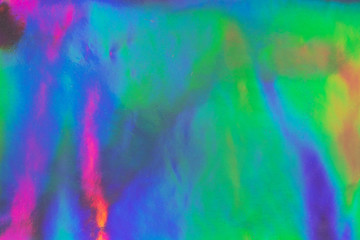 Fototapeta na wymiar Photo texture of a fashionable holographic film. Abstract colorful holographic futuristic texture.