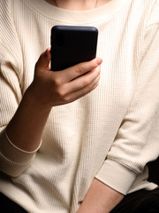 Close-up of a woman using mobile smart phone. Smartphone in female hands