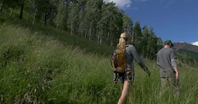 Couple Hiking Colorado Mountain Trail with Dog Tall Grass