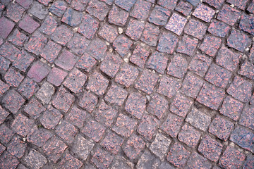 Background. The road is made of granite cobblestones.