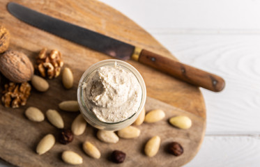 Homemade organic vegan butter made from almonds on a white background.