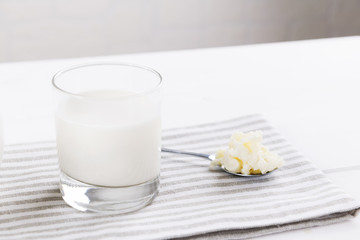 Homemade fermented beverage kefir with kefir grains in bowl on a white background, concept of natural fermented food and intestinal health