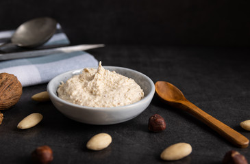 Homemade organic vegan butter made from almonds on a white background.