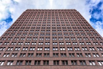 A tall building against an overcast dark sky.