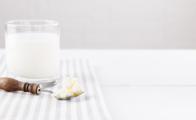 Homemade fermented beverage kefir with kefir grains in bowl on a white background, concept of natural fermented food and intestinal health