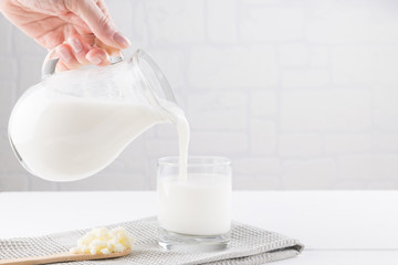 Homemade fermented beverage kefir with kefir grains in bowl on a white background, concept of...