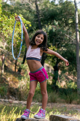 Fototapeta premium Cute girl posing with hula hoop