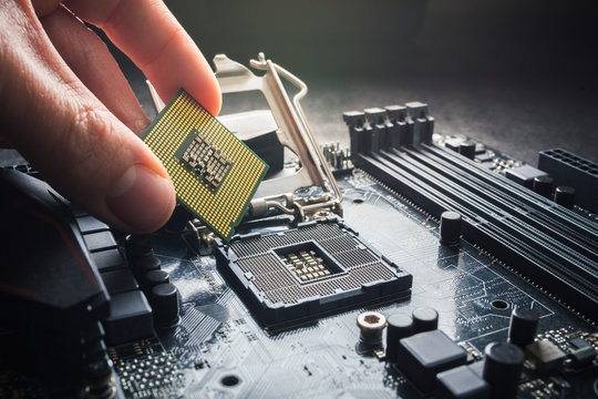 Electronic engineer of computer technology. Maintenance computer cpu hardware upgrade of motherboard component. Pc repair, technician and industry support concept. Close up photo.