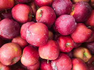 ripe, but not very beautiful and poorly washed red-yellow apples of small size and on the store counter
