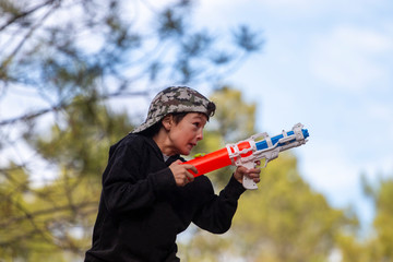 Naklejka premium Cute boy with water gun
