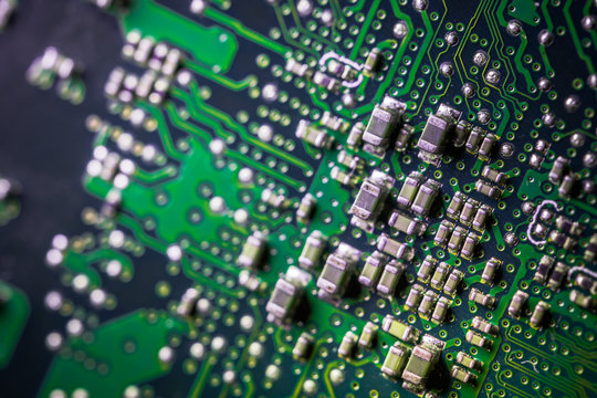 Circuit board. Electronic computer hardware technology. Motherboard digital chip. Tech science background. Integrated communication processor. SMD resistors and capacotors. Green PCB.