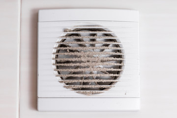The white grille for the exhaust fan is dirty. Concept of indoor air pollution.