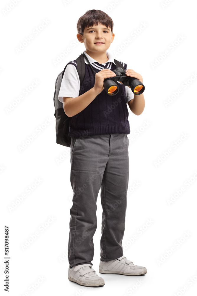 Wall mural schoolboy with a backpack holding binoculars and smiling at the camera