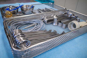 in an operating theatre there is a basic screen for general surgery on a blue sheet.