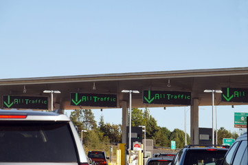 Cars waiting at the border between Canada and the United States. Hot day, hot air waves over hot cars.