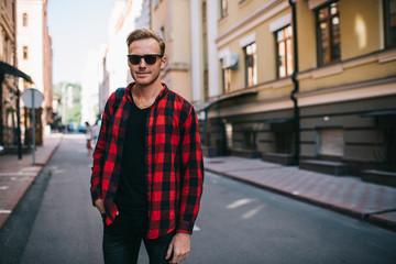 Smiling adult man on street in sunny summer day